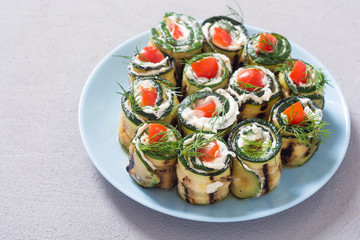 Zucchini rolls with cream cheese , tomatoes and dill