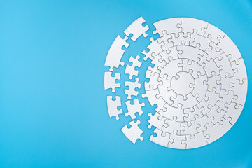 Unfinished white jigsaw puzzle pieces on blue background, The last piece of jigsaw puzzle, Copy...