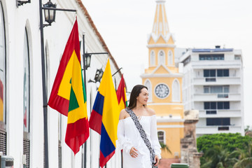 Beautiful woman walking around Cartagena de Indias next to the famous Clock Tower
