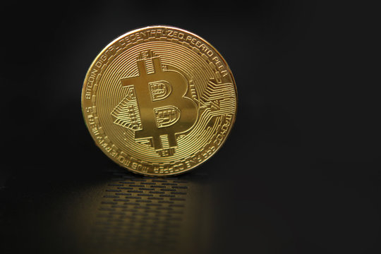 electronic coin, golden coin on a dark background, concept, copy space, close-up, horizontal