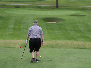 a golfer prepares to hit a tee shot on a par 3