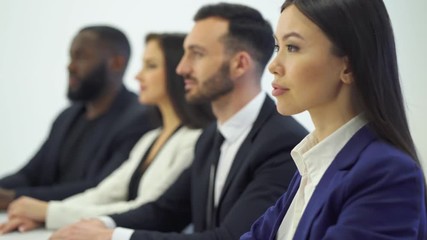 The four international business people sitting at the table