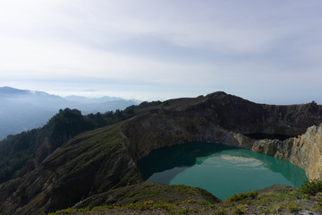 Panorama of kelimutu lake in Kelimutu Flores-Indonesia national park on a clear day. Lake water is turquoise and black green