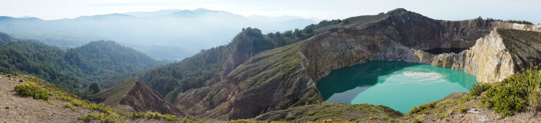 Fototapeta na wymiar Panorama of kelimutu lake in Kelimutu Flores-Indonesia national park on a clear day. Lake water is turquoise and black green