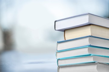 Stack books collection on library background