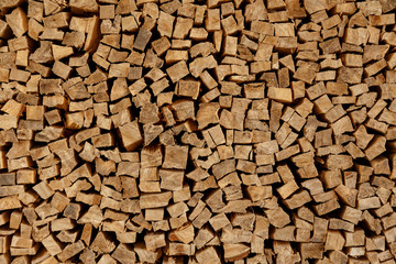 The texture of wooden firewood, randomly split and laid in straight rows
