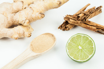 Ginger root with lemon and cinnamon photo on neutral background