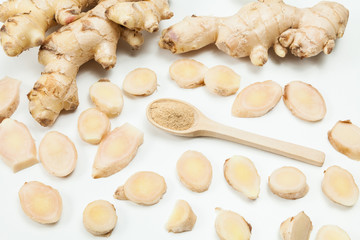 Fresh roots and ginger powder - Zingiber officinale; photo on neutral background