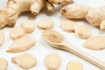 Fresh roots and ginger powder - Zingiber officinale; photo on neutral background