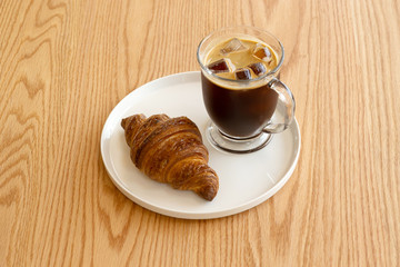 Ice coffee and croissant. breakfast.