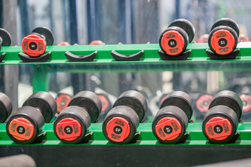 The background of the exercise equipment set for good health (steel balls, dumbbells, cable, weightlifting, boxing boxing gloves, fitness balls) has a blurred light that Fall 