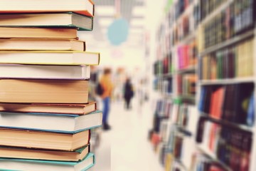 Old books stacked on blurred bokeh background
