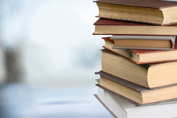 Collection of old books stack on blurred  background
