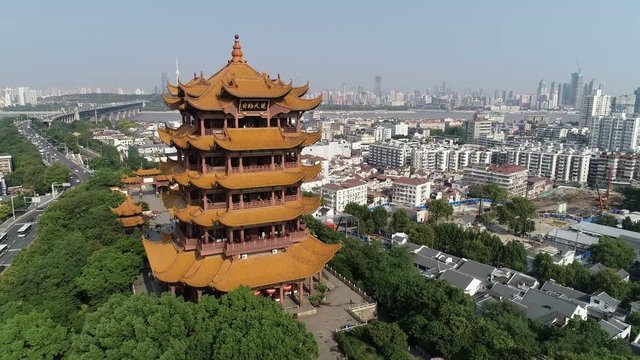 Flying past famous historic Yellow Crane Tower reveals modern skyline and Yangtze river in Wuhan, China