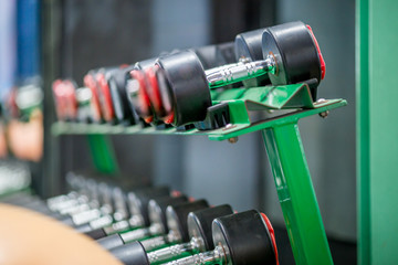 The background of the exercise equipment set for good health (steel balls, dumbbells, cable, weightlifting, boxing boxing gloves, fitness balls) has a blurred light that Fall 