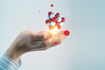 Businessman hands holding a bunch of spheres levitating above. Mixed media