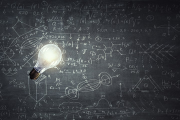 Fototapeta premium Light bulb on chalk board background