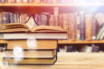 Collection of old books and glasses on