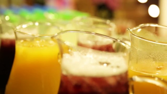 Taste juices in glass jars on a table. The image is in close up and blurrd background