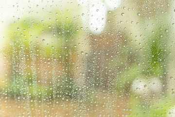 Rain drops on the glass, blurred background