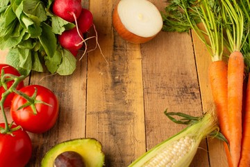 Frame with fresh vegetables. On wooden background. Veggie set.flat lay. Harvesting. Gastronomy