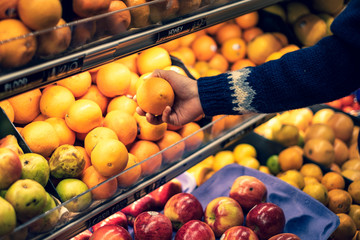 Hand holding an orange