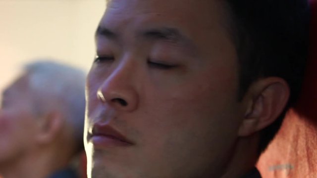 Asian man jet lag tired red eyes insomnia long flight travel