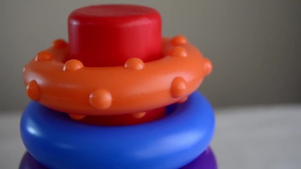educational toy close up pan right revealing shot diferent sized rings on the stand