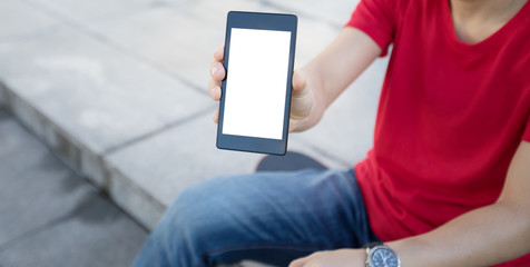 one skateboarder sit on skateboard use mobile phone at city