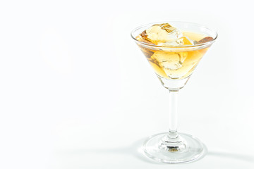 Alcohol drink with ice cubes isolated on white background.