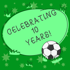 Writing note showing Celebrating 10 Years. Business photo showcasing Commemorating a special day Decennial anniversary Soccer Ball on the Grass and Blank Outlined Round Color Shape photo