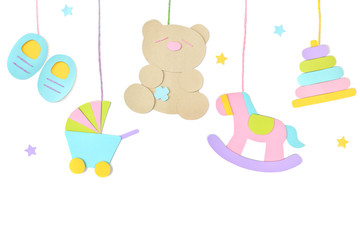 Baby toys hanging paper cut on white background - isolated