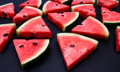 Watermelon on a black backdrop in the studio.