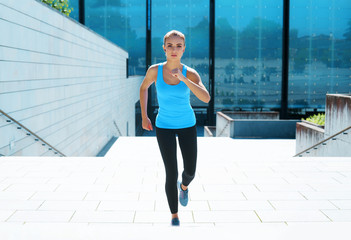 Naklejka premium Young, fit and sporty brunette girl in sportswear. Woman doing sports outdoor.
