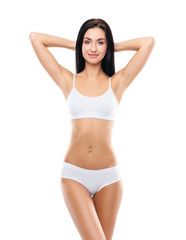 Young, fit and beautiful brunette girl in white swimsuit.