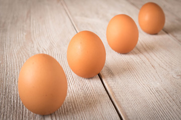 Chicken eggs on a wooden table. Selective focus.