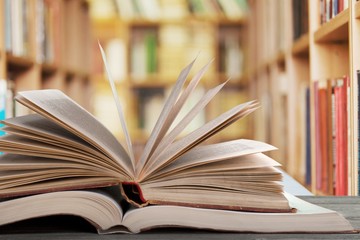Open book on old wooden table at
