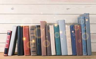 Ancient books in a row on wooden