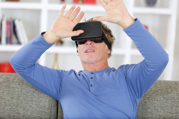 scared man taking off virtual reality headset