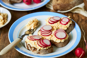Sandwiches with boiled grated eggs and fresh radish