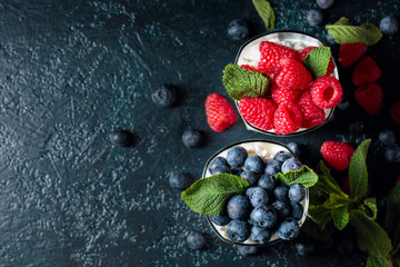 Cottage cheese with cream, raspberry and blueberry garnished with fresh mint. © Igor Normann