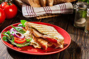 Toasted panini with ham, cheese and tomato sandwich
