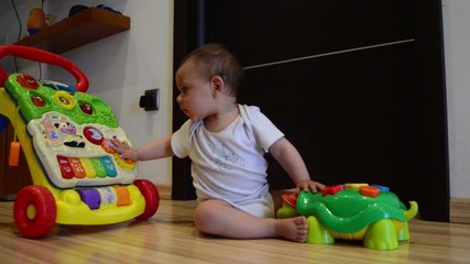 static shot, cute seven months old baby boy playing with educational toys on the floor happy childhood,early development concept