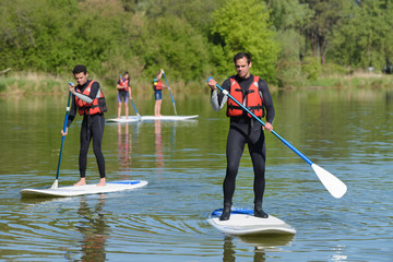 group of people on paddle boards on a lake