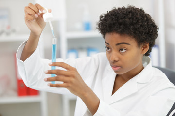 young  female scientist witha pipette in the laboratory