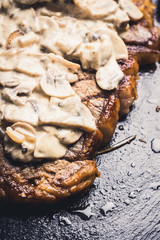 Grilled T-bone steak on the stone board. Selective focus. Shallow depth of field.