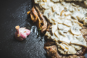 Grilled T-bone steak on the stone board. Selective focus. Shallow depth of field.