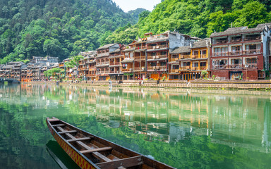 Scenic view of Fenghuang phoenix ancient town with Tuo Jiang river boat and old houses Hunan China
