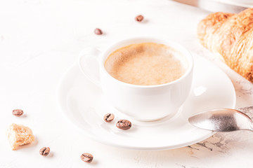 Traditional breakfast with fresh croissants on white background.