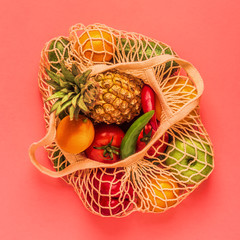 Fresh vegetables and fruits in bag mesh.
